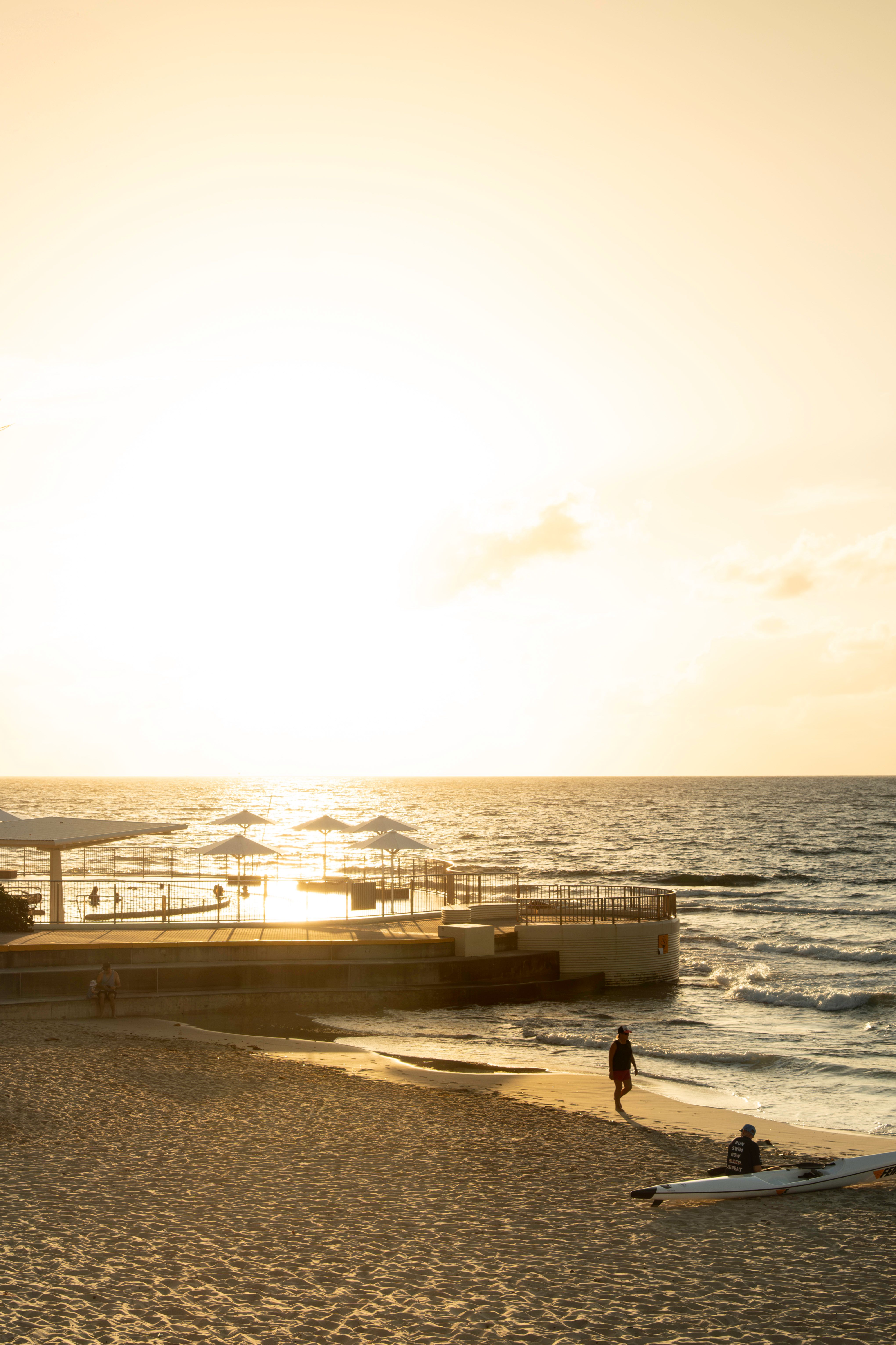 Golden-hour light over the Caloundra beach and ocean pool